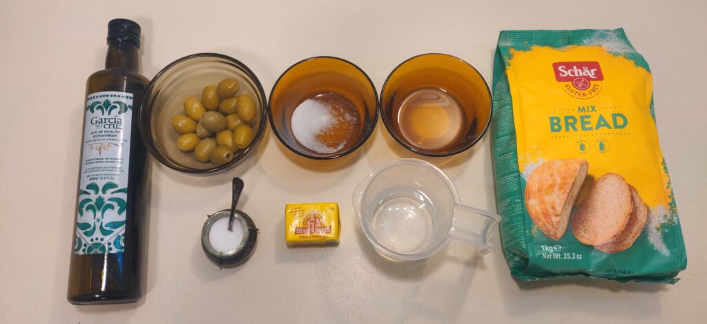 A bunch of simple ingredients that are prepared for a gluten free olive rolls recipe